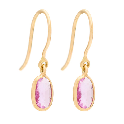 Gold earrings with pink gemstones on a white background